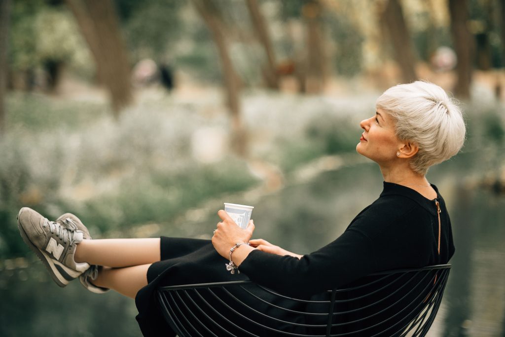 older woman relaxing with a beverage