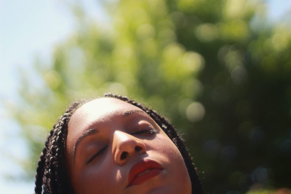 woman with eyes closed and sunlight on face